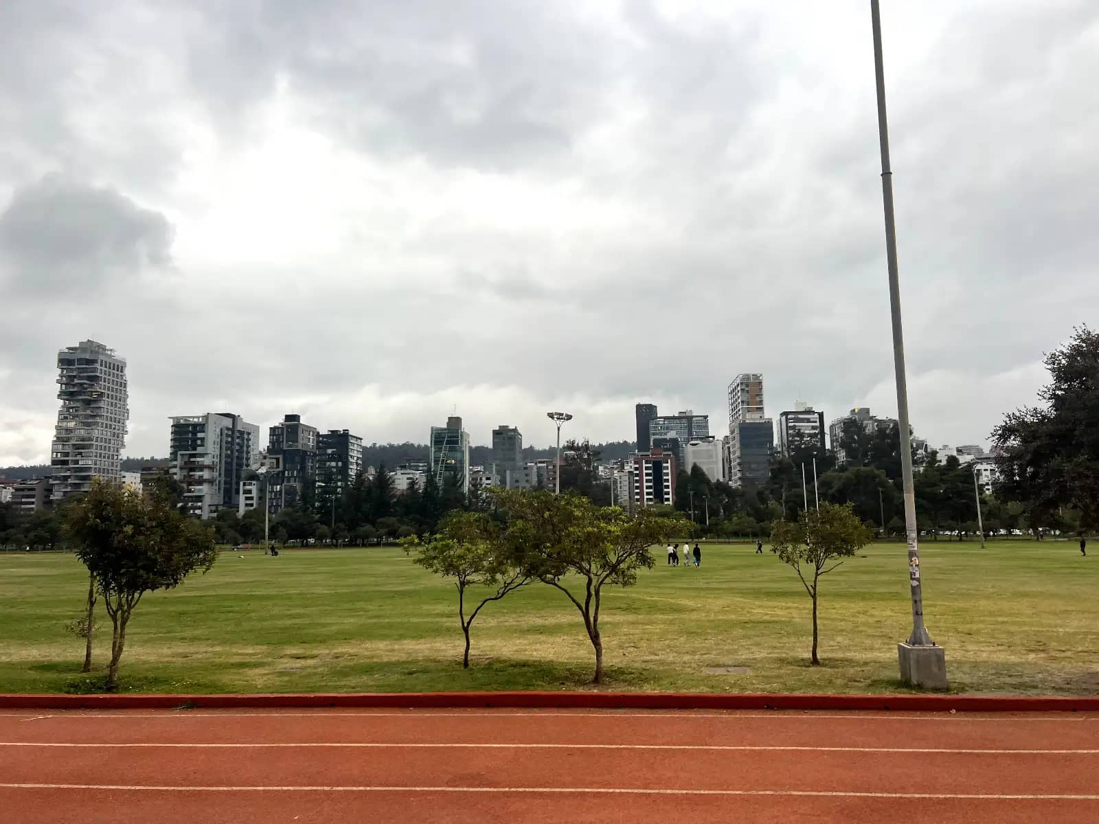 La Carolina Park running track and open grass field with Quito city skyline in background Ecuador walking distance from Hotel Altura