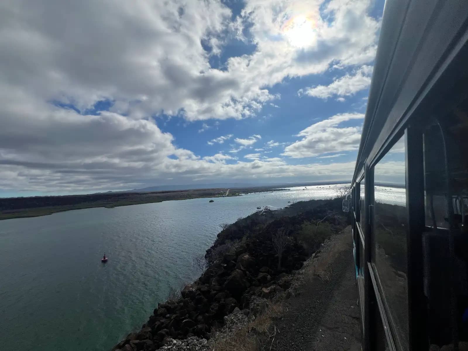 View from $10 public airport bus traveling along causeway from Seymour Galápagos Ecological Airport GPS to Baltra Port channel Santa Cruz Island Ecuador